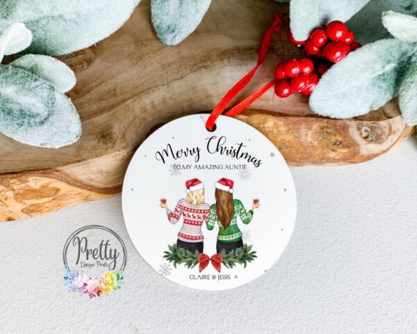 Personalisable christmas Bauble with x2 female characters wearing christmas hats and christmas jumpers
