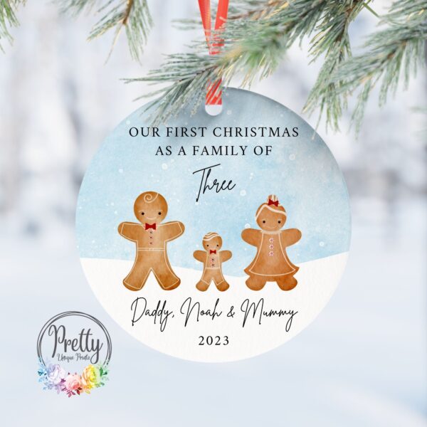 Personalised Bauble with x3 gingerbread characters. Quote saying *Our first Christmas As a Family of 3*. Also has a snow scene background