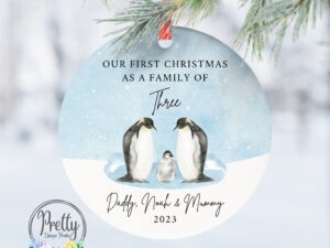 Christmas Bauble with 3 penguins & quote saying our first Christmas as a family of three